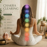 Woman in a yoga pose with chakra symbols above her head, set against a neutral background.