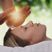 women receiving healing reiki energy on top of her head 